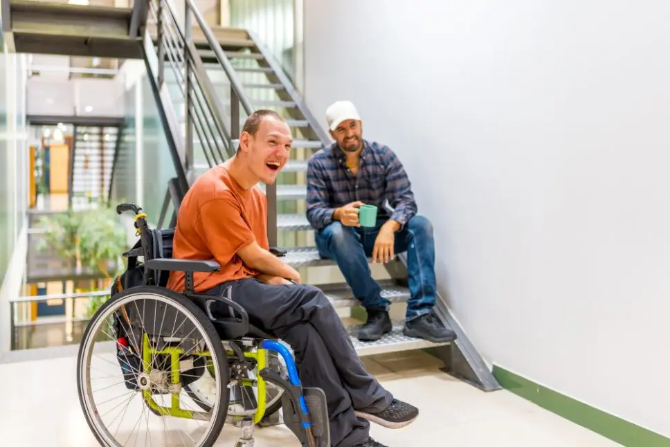 Happy-work-mates-with-disability-having-fun-in-a-work-break